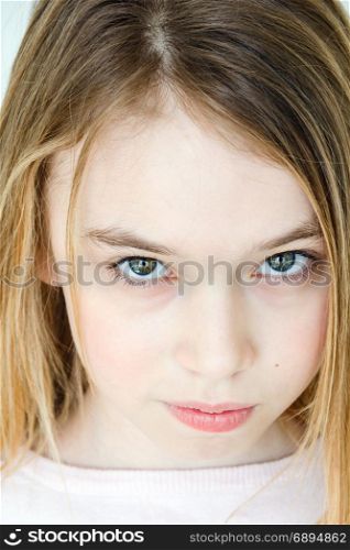Cute girl eleven years old with blond long hair and green eyes