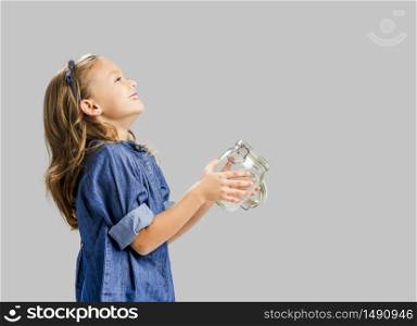 Cute girl holding a glass pot and release something