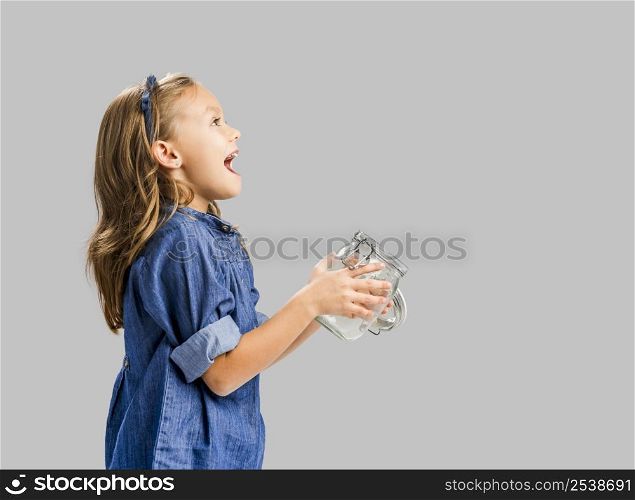 Cute girl holding a glass pot and release something