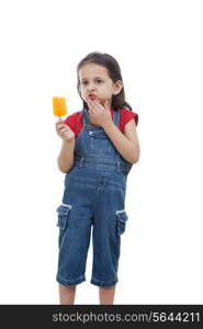 Cute girl holding flavored ice over white background