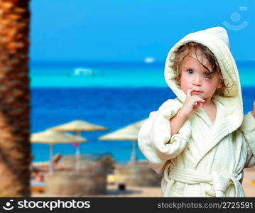 cute girl in bathrobe portrait on tropical beach