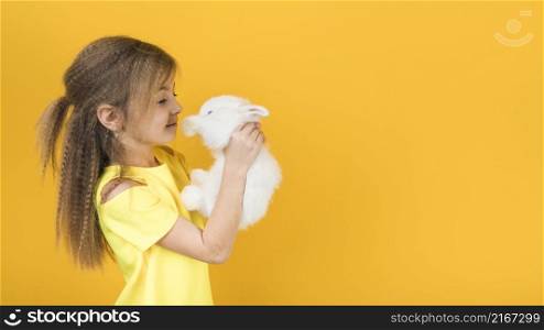 cute girl looking white rabbit
