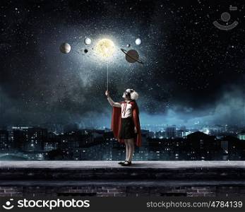 Cute girl of school age exploring space system. I will be astronaut