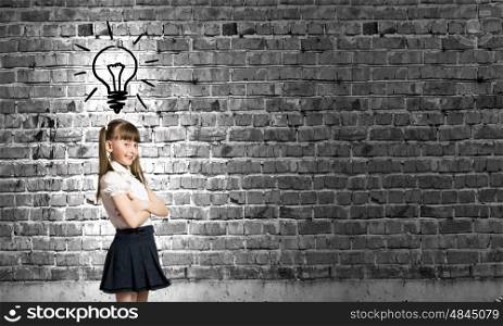Cute girl of school age. Pretty schoolgirl and light bulb. Idea concept