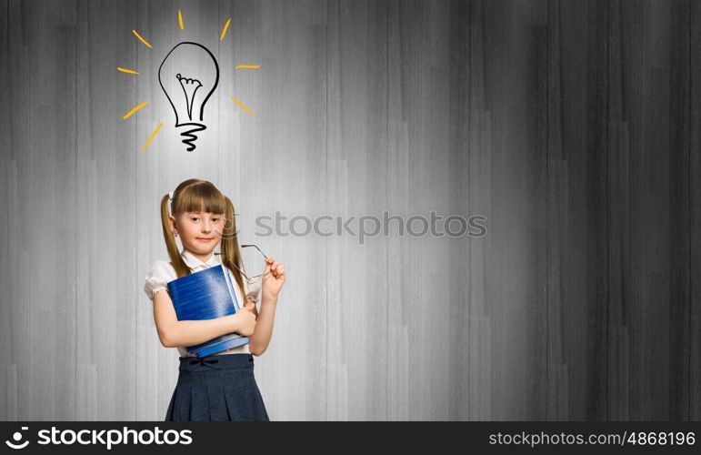 Cute girl of school age. Pretty schoolgirl and light bulb. Idea concept