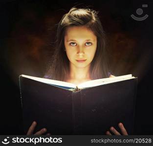 Cute girl opening the magic book