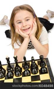 Cute girl playing chess on white