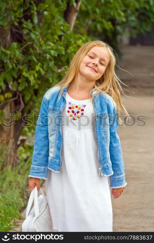 Cute girl playing with white bag in summer