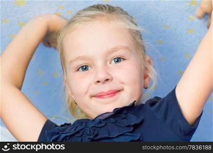 Cute girl seven years old with upward hands