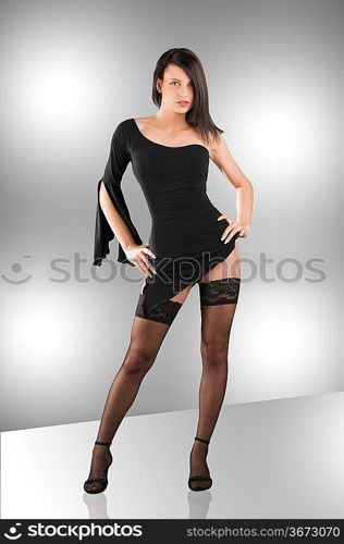 cute girl wearing a sexy black dress and showing stocking