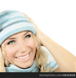 Cute girl wearing blue winter hat, beautiful young woman close up on smiling female face, happy teen dressed up in warm clothing looking up, isolated