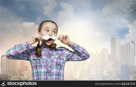 Cute girl wearing shirt hat and mustache. Kid having fun
