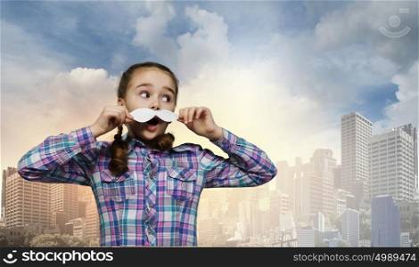 Cute girl wearing shirt hat and mustache. Kid having fun