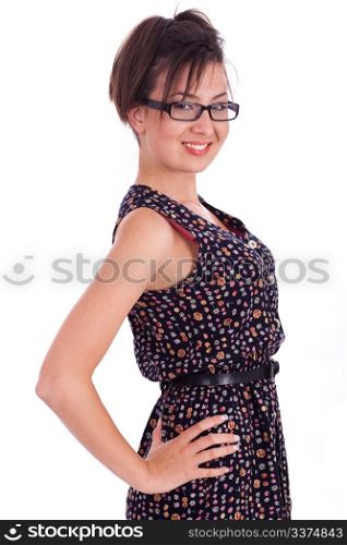 Cute girl wearing spectacles with hands on hips side pose over white background