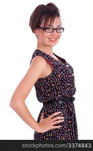 Cute girl wearing spectacles with hands on hips side pose over white background