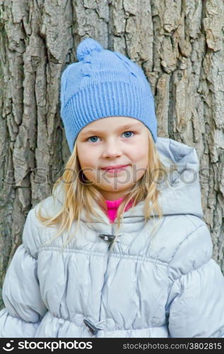 Cute girl with blond long hair and blue eyes