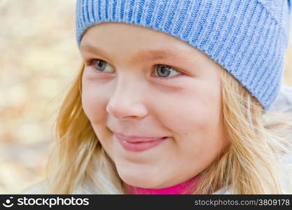 Cute girl with blond long hair and blue eyes