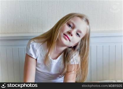 Cute girl with blond long hair and blue eyes