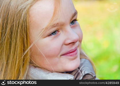 Cute girl with blond long hair and blue eyes