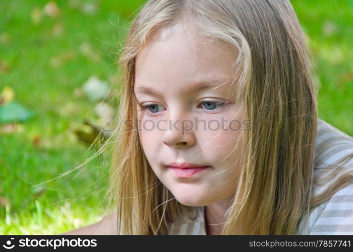 Cute girl with blond long hair and blue eyes