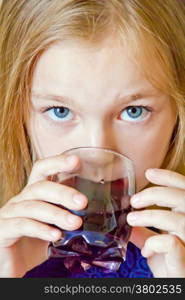 Cute girl with blond long hair drinking beverage