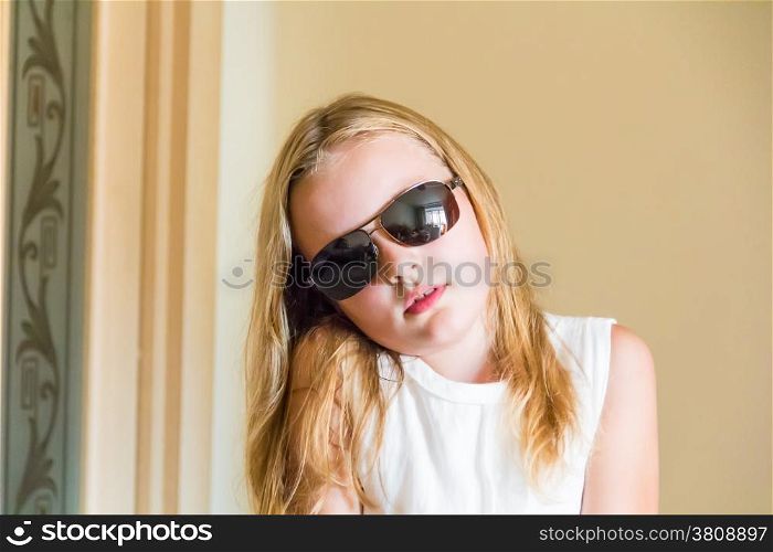 Cute girl with blond long hair in sunglass