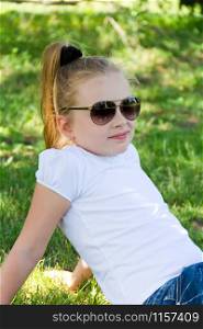 Cute girl with blond long hair in sunglasses