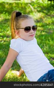 Cute girl with blond long hair in sunglasses