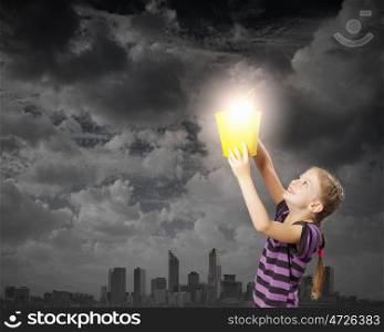 Cute girl with bucket trying to catch the sun