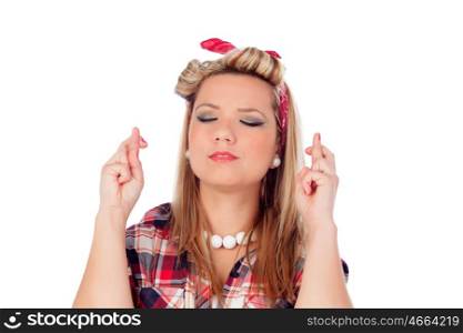 Cute girl with fingers crossed for wanting to be luckyin and pinup style isolated on a white background