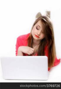 cute girl with headphones listening to music on the laptop on white background
