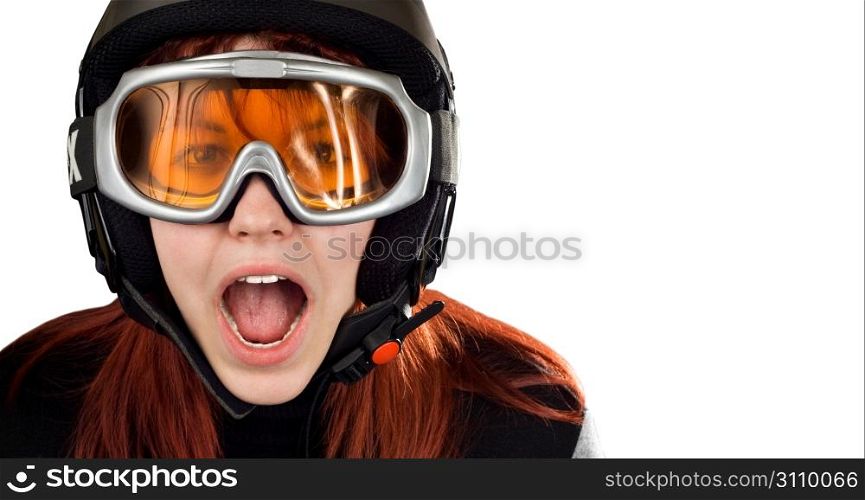 Cute girl with red hair wearing a ski helmet and orange goggles acting surprised and yelling. Feeling cold. Studio shot.