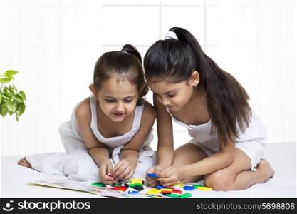 Cute girls solving puzzle