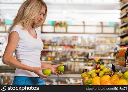 Cute happy brunette shopping in a grocery store, organic food section