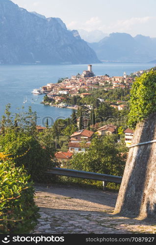 Cute idyllic Italian village, moutain road and lake captured from above. Malcesine at lago di Garda.