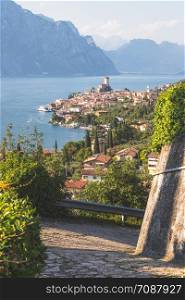 Cute idyllic Italian village, moutain road and lake captured from above. Malcesine at lago di Garda.
