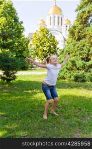 Cute jumping girl with blond hair in summer