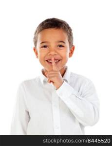 Cute kid has put forefinger to lips as sign of silence, isolated on a white background