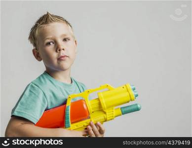 cute kid playing with water gun
