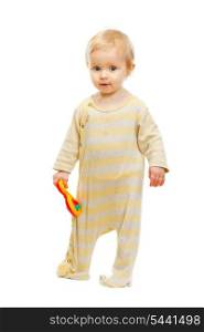 Cute kid standing with rattle on white background