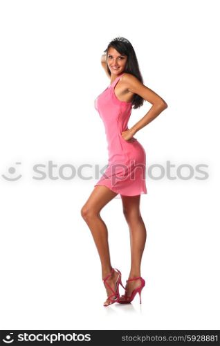 Cute latin woman flirting and smiling in a pink dress in studio on white background
