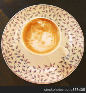 Cute latte art coffee with cat face, retro filter effect