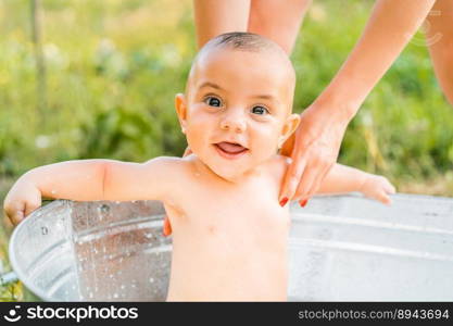 Cute little baby boy portrait in milk bath. Healthy lifestyle. child in summer garden, nature concept. Cute little smiling baby boy portrait in milk bath. Healthy lifestyle. 