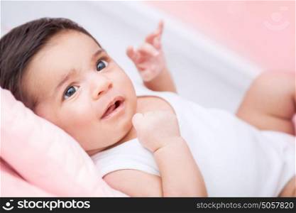 Cute little baby portrait, sweet adorable newborn child lying down on bed at home, healthy lifestyle, happy childhood concept