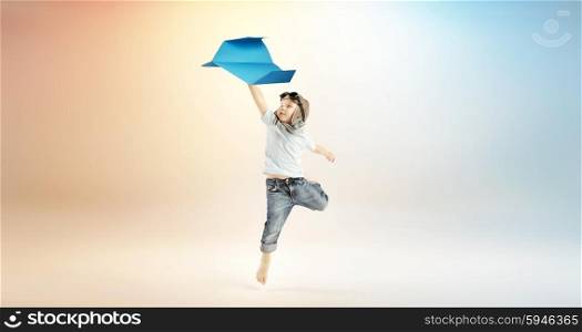 Cute little boy flying with the paper toy plane