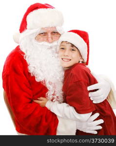 Cute little boy gives Santa Claus a big hug. Isolated on white.