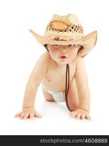 Cute little boy having fun in cowboy hat and diaper isolated on white background, adorable child crawling in studio