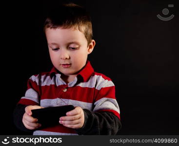 Cute little boy holding a portable video game