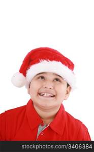 Cute little boy in Santa hat, looking up to copy space