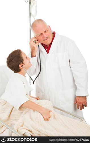 Cute little boy in the hospital being entertained by a friendly doctor. Isolated on white.